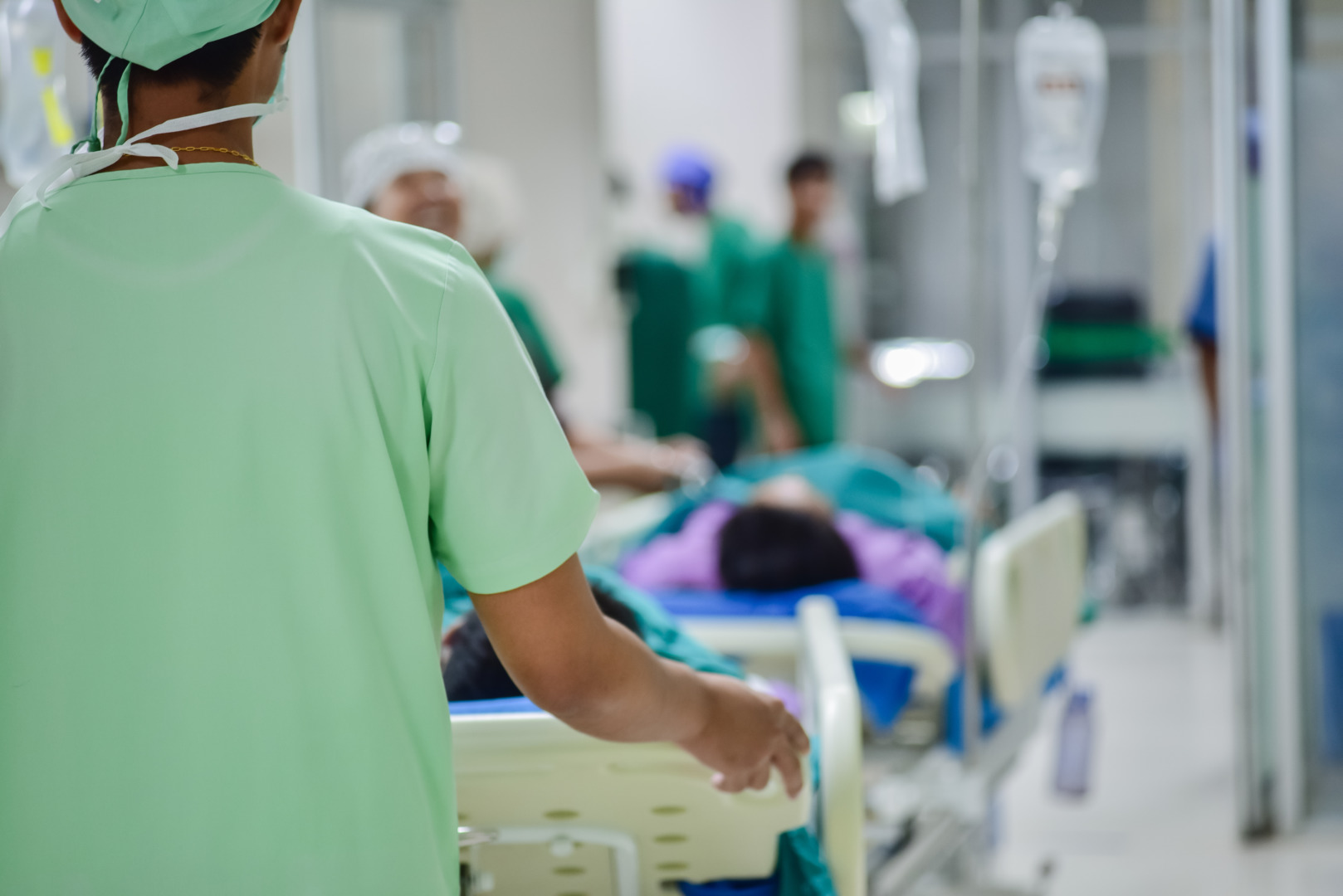 Blurred,Of,Medical,Team,Moving,Patient,To,Surgery,In,Operating